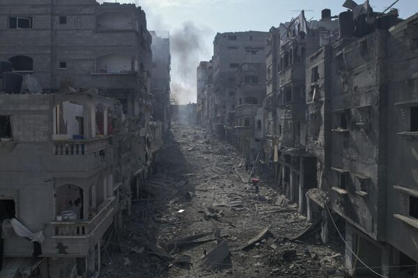 Rubble litters a street between smoldering buildings hit by an Israeli airstrike in Jabaliya, the Gaza Strip, Wednesday, Oct. 11, 2023.  - Sputnik Africa