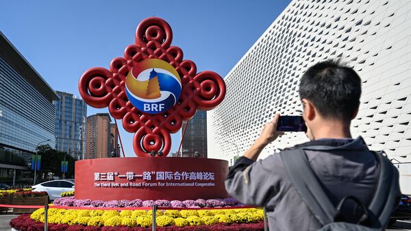A man photographs the installation of the One Belt, One Road forum in Beijing, China - Sputnik Africa