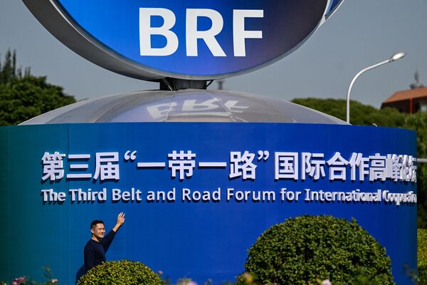 A man poses next to an installation of the Belt and Road Forum in Beijing on October 16, 2023. - Sputnik Africa