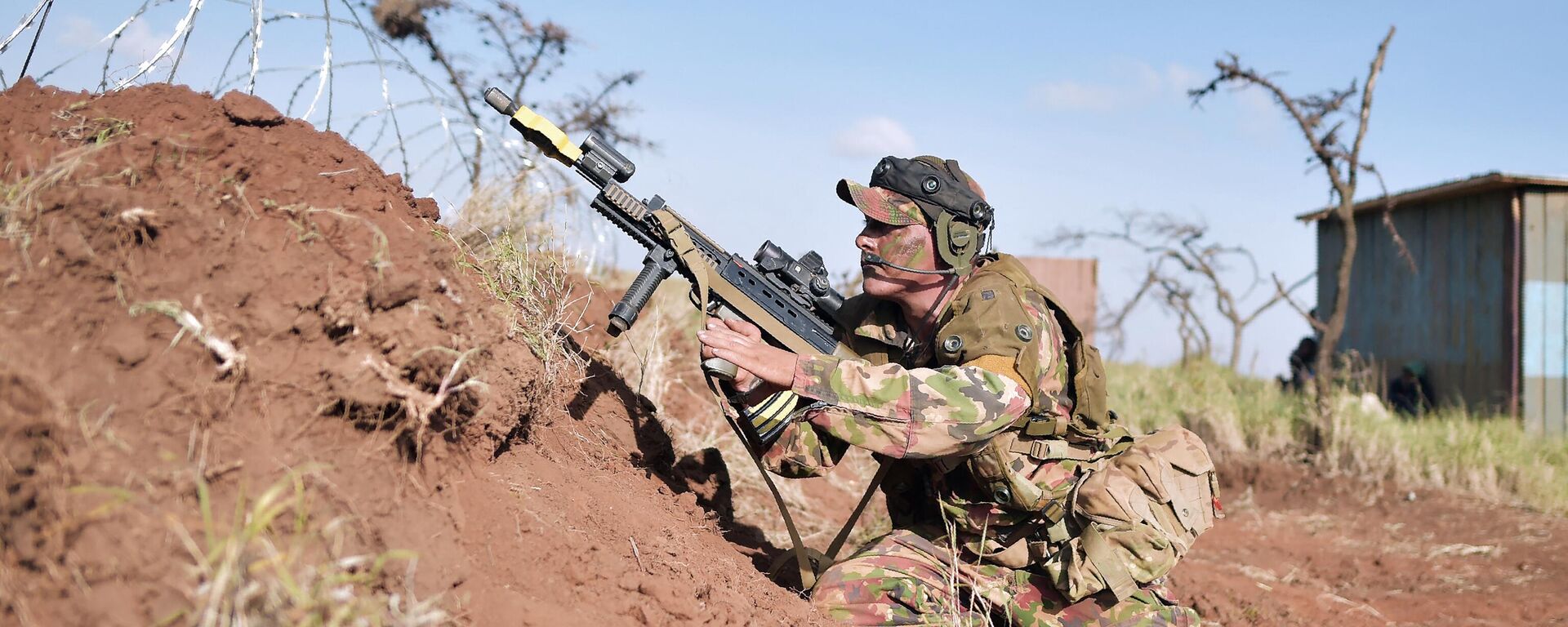 A soldier shuffles back to position to fire his machine gun during a simulated military excercise of the British Army Training Unit in Kenya (BATUK) together with the Kenya Defence Forces (KDF) at the ol-Daiga ranch, high on Kenya’s Laikipia plateau on March 27, 2018.  - Sputnik Africa, 1920, 30.10.2023