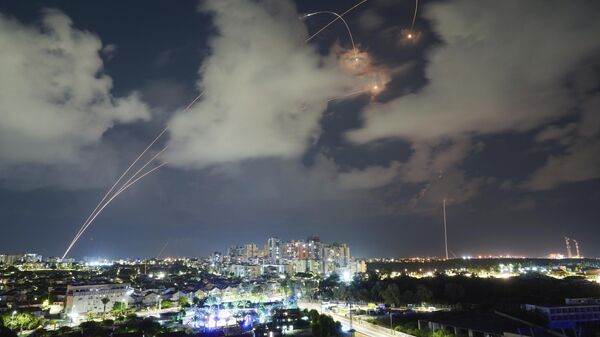 Rockets from the Israeli Iron Dome air defense system maneuver to intercept a rocket fired from the Gaza Strip, in Ashkelon, Israel, Thursday, Oct. 19, 2023.  - Sputnik Africa
