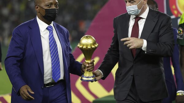 Confederation of African Football President Patrice Motsepe, left, and FIFA President Gianni Infantino hold the African Cup of Nations 2022 trophy after the final soccer match between Senegal and Egypt at the Olembe stadium in Yaounde, Cameroon, Feb. 6, 2022.  - Sputnik Africa