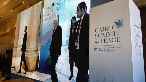 Seen on a large screen the Palestinian president Mahmud Abbas arrives to attend the International Peace Summit hosted by the Egyptian president in Cairo on October 21, 2023, amid the ongoing battles between Israel and the Palestinian group Hamas. - Sputnik Africa