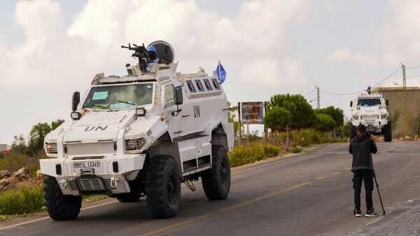 A journalist films U.N. peacekeepers patrol on the Lebanese side of the Lebanese-Israeli border in the southern village of Marwahin, Lebanon - Sputnik Africa