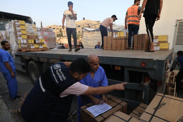 Workers unload medical aid from the World Health Organization at the Nasser hospital in Khan Yunis in the southern Gaza Strip on October 23, 2023. An aid convoy entered the besieged Gaza Strip through the Rafah border crossing on October 23, the third since the outbreak of violence on October 7. - Sputnik Africa