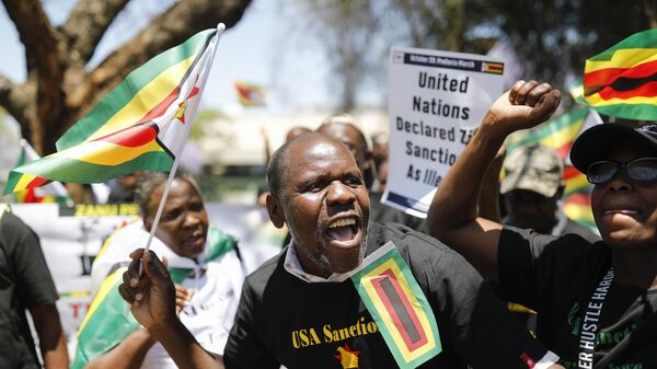 Members of the World Wide Forum for Economic Development gather to picket against sanctions imposed by the US on Zimbabwe at the US Embassy in Pretoria on October 25, 2023.  - Sputnik Africa