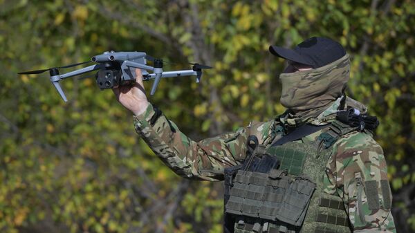 A serviceman of the Russian Armed Forces adjusting the fire of tank units using a UAV in the Zaporozhye region. - Sputnik Africa