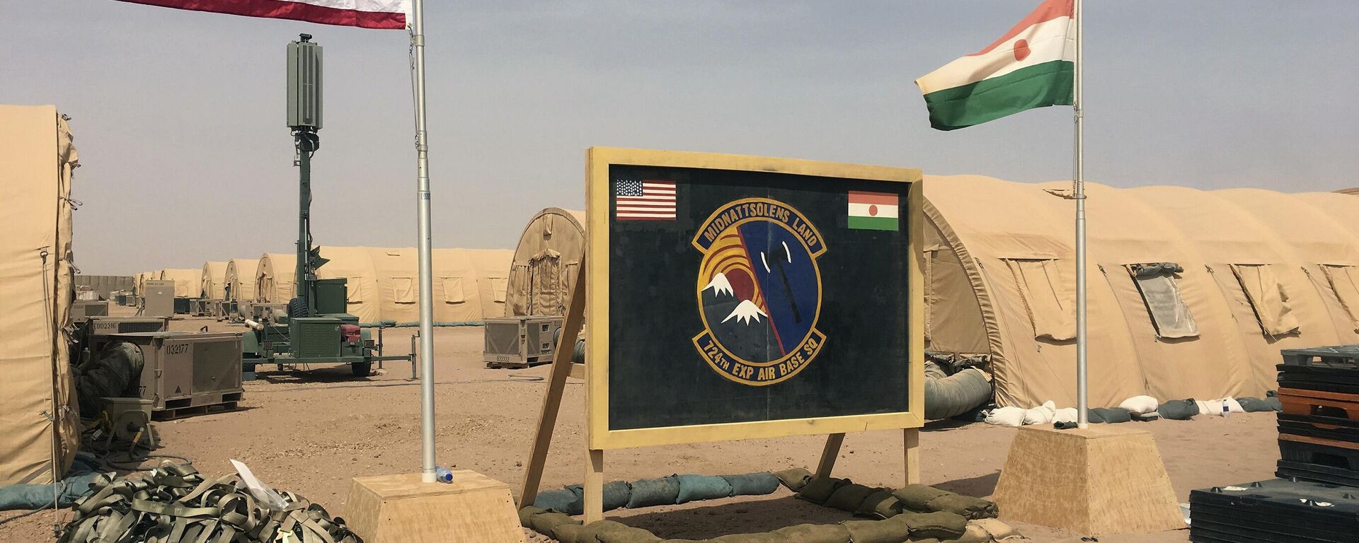 In this photo taken Monday, April 16, 2018, a U.S. and Niger flag are raised side by side at the base camp for air forces and other personnel supporting the construction of Niger Air Base 201 in Agadez, Niger. On the scorching edge of the Sahara Desert, the U.S. Air Force is building a base for armed drones, the newest front in America's battle against the growing extremist threat in Africa's vast Sahel region. Three hangars and the first layers of a runway command a sandy, barren field. Niger Air Base 201 is expected to be functional early next year.  - Sputnik Africa, 1920, 29.03.2024