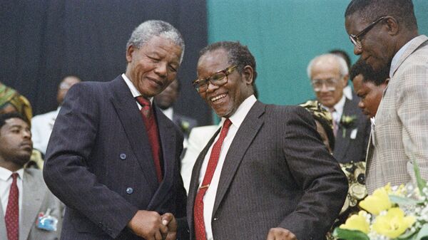 ANC deputy president Nelson Mandela shakes the hand of Oliver Tambo African National Congress President in Durban on July 02, 1991 for the first ANC national congress to be held on South African soil in the past 30 years. - Sputnik Africa
