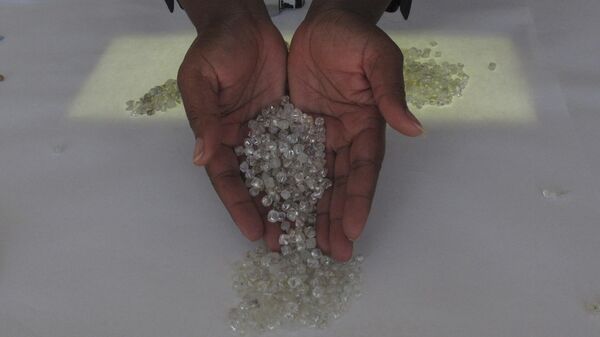 A fistful of diamonds held by Dina Muhimba as she sorts gemstones at the Namibia Diamond Trading Company in Windhoek, Namibia, in this photo dated Wednesday, June 14, 2017.  - Sputnik Africa