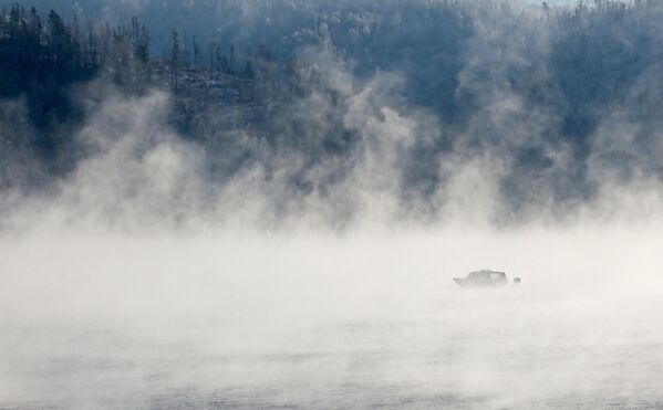 A motor boat on the Yenisey River moves through frosty vapors in the taiga in the Krasnoyarsk region. - Sputnik Africa