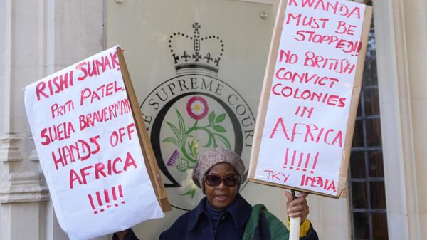A protester stands outside the Supreme Court in London, Wednesday, Nov. 15, 2023 - Sputnik Africa