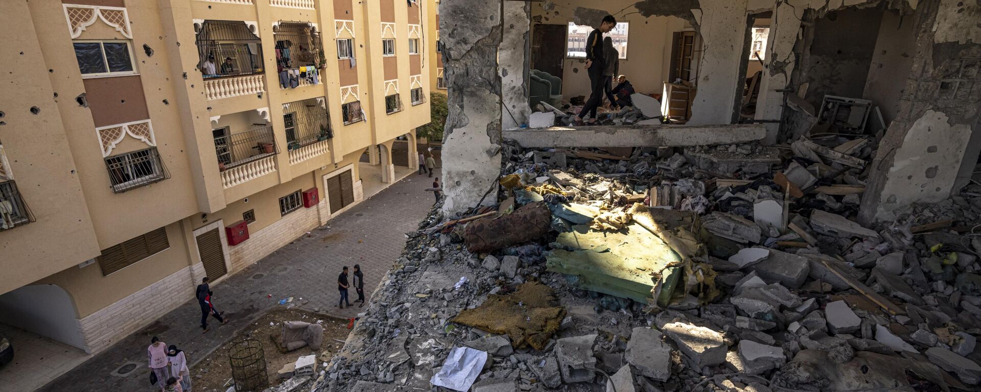 Palestinians look at destruction after an Israeli strike on the Gaza Strip in Khan Younis, Saturday, Nov. 18, 2023. (AP Photo/Fatima Shbair) - Sputnik Africa, 1920, 18.11.2023
