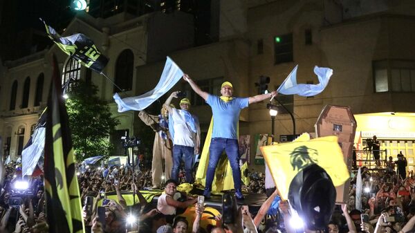 Supporters of the Argentine presidential candidate for the La Libertad Avanza alliance, Javier Milei, celebrate his victory in the presidential election runoff outside the party headquarters in Buenos Aires on November 19, 2023 - Sputnik Africa
