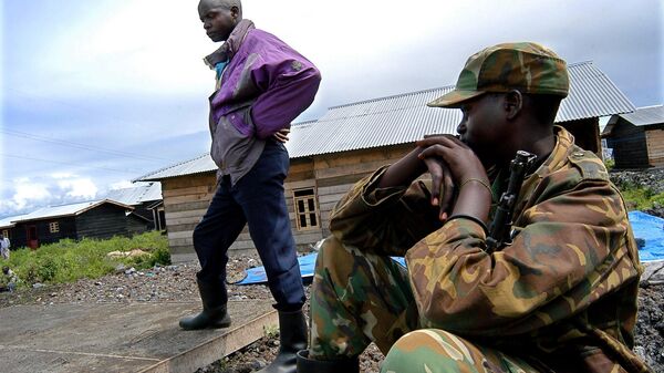 A Democratic Forces for the Liberation of Rwanda soldier, center, Sgt. Jean de Dieu Ngendahimana is watched by a Congolese soldier after he surrended to the Congolese army Thursday, April 29, 2004, in the outskirt of the city of Goma in the Democratic Republic of Congo. Rwandan rebels threaten to derail the first chance to have real peace in the region in a decade.  - Sputnik Africa