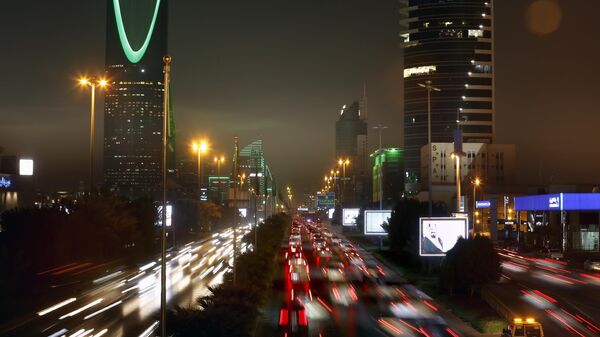 In this Sept. 22, 2019 file photo taken with a slow shutter speed, vehicles pass in front of the landmark Kingdom Tower, at left, during celebrations marking Saudi 89th National Day, in Riyadh, Saudi Arabia. - Sputnik Africa