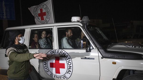 Un véhicule de la Croix-Rouge transportant des otages israéliens passe au point de passage de la bande de Gaza vers l'Égypte à Rafah, le 25 novembre 2023 - Sputnik Afrique