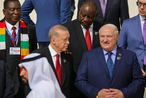 Belarus&#x27; President Alexander Lukashenko (R) listens to his Turkish counterpart Recep Tayyip Erdogan as they arrive for a family photo with participating world leaders and delegates during the COP28 United Nations climate summit in Dubai on December 1, 2023. - Sputnik Africa