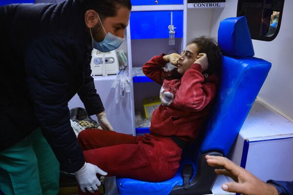 An injured girl sits in an ambulance following an Israeli air strike on the Rafah refugee camp in the southern Gaza Strip on December 1, 2023. - Sputnik Africa