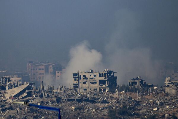 This picture taken from southern Israel near the border with the Gaza Strip shows smoke rising from buildings still smoldering after being hit by Israeli strikes in the battles between Israel and Hamas militants, on December 1, 2023. - Sputnik Africa