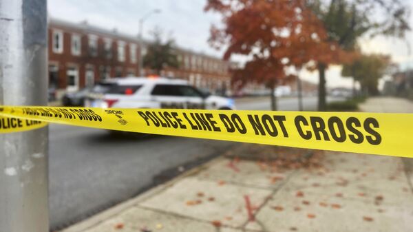 Crime scene tape sections off the scene of a shooting, Tuesday, Nov. 7, 2023, in southwest Baltimore, where police shot a man they said pointed a gun at officers. - Sputnik Africa