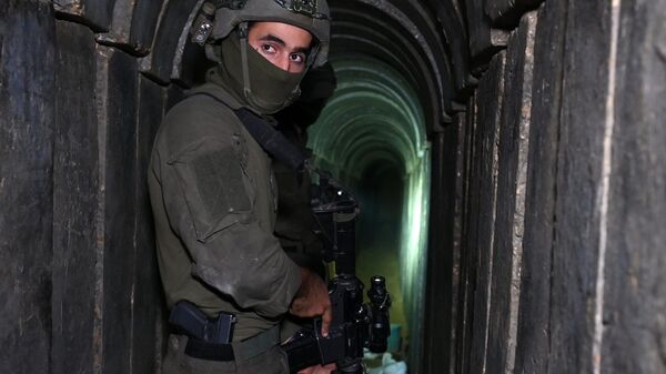 A soldier stands in what the Israeli army says is a tunnel dug by Hamas militants inside the Al-Shifa hospital complex in Gaza City in the northern Gaza Strip, amid continuing battles between Israel and the Palestinian militant group Hamas, on November 22, 2023 - Sputnik Africa
