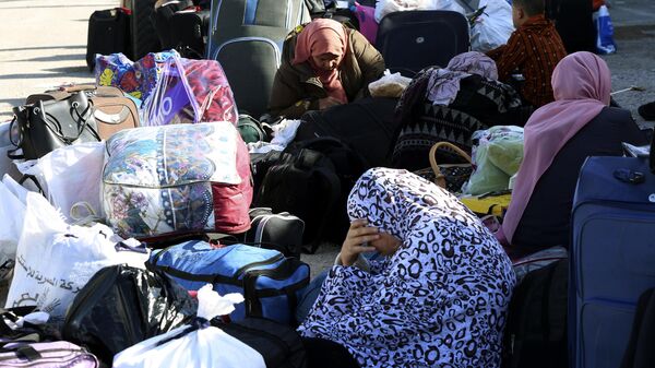 Palestinians stranded in Egypt wait to cross Rafah crossing to the Gaza Strip in Rafah, Egypt, as a temporary ceasefire went into effect Friday, Nov. 24, 2023. - Sputnik Africa