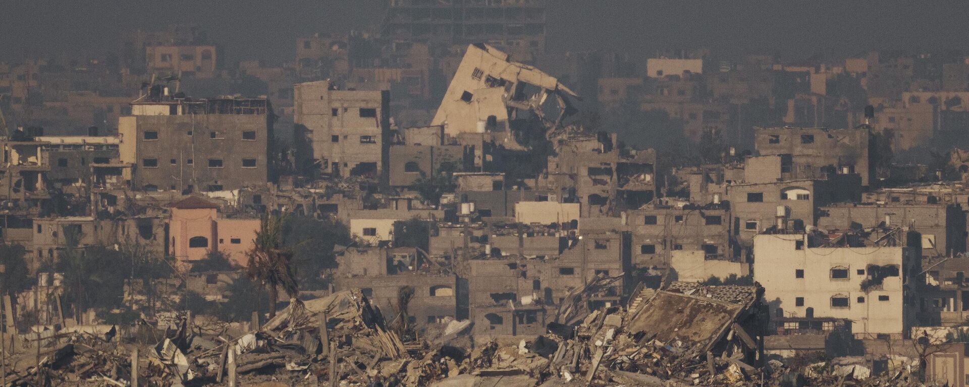 Destroyed buildings from Israeli airstrikes are seen in the northern Gaza Strip, as seen from southern Israel, Thursday, Dec. 7, 2023.  - Sputnik Africa, 1920, 22.04.2024