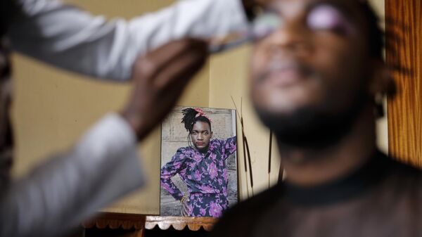 Raymond Brian, a Ugandan refugee and a nonconforming gender person who also goes by the name of “Mother Nature,” has makeup done in a house at a house that serves as a shelter for LGBT refugees  - Sputnik Africa