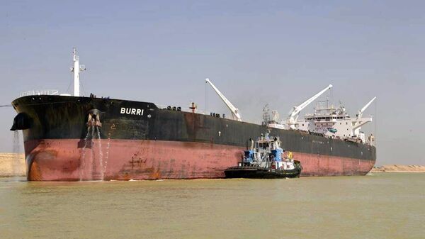 In this handout photo released by the Suez Canal Authority on August 23, 2023, a ship, The Burri, and a tugboat are shown in the waterway after a collision with another large transport vessel. - Sputnik Africa