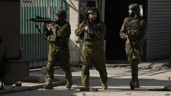 Israeli soldiers are seen during an army operation, in the Jenin refugee camp, West Bank, Tuesday, Dec. 12, 2023.  - Sputnik Africa