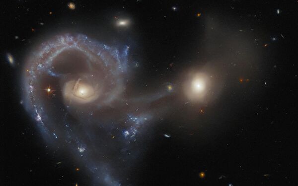 This Hubble Picture of the Week — taken using NASA/ESA Hubble Space Telescope’s Advanced Camera for Surveys (ACS) — shows Arp 107, a celestial object that comprises a pair of galaxies in the midst of a collision. The larger galaxy (in the left of this image) is an extremely energetic galaxy type known as a Seyfert galaxy, which house active galactic nuclei at their cores.  - Sputnik Africa