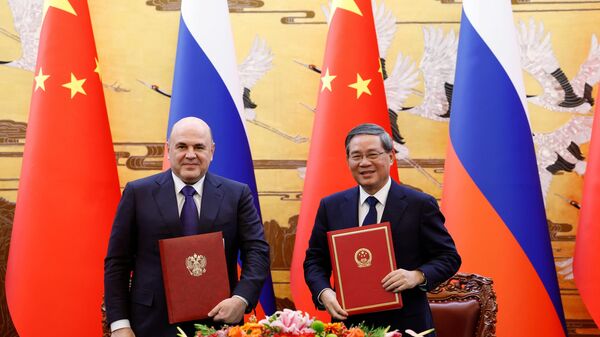December 19, 2023. Prime Minister of the Russian Federation Mikhail Mishustin and Prime Minister of the State Council of the People's Republic of China Li Qiang during the signing of joint documents following the 28th regular meeting of the heads of government of Russia and China. - Sputnik Africa
