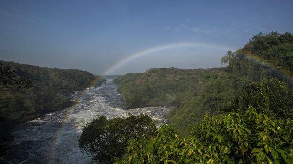 A rainbow forms in the mist at the top of the waterfalls in Murchison Falls National Park, northwest Uganda, on Feb. 22, 2020. - Sputnik Africa