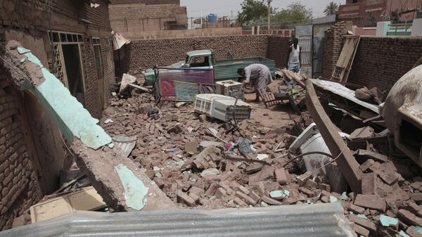 A man cleans debris of a house hit in recent fighting in Khartoum, Sudan, Tuesday, April 25, 2023.  - Sputnik Africa