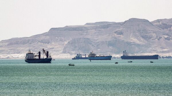 This picture taken on March 28, 2021 shows tanker and freight ships near the entrance of the Suez Canal, by Egypt's Red Sea port city of Suez. - Sputnik Africa