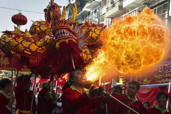A fire breather blows flames as a troupe performs a traditional dragon dance during the first day of Chinese Lunar New Year in Yangon&#x27;s Chinatown district on January 28, 2017. This Lunar New Year marks the start of the Year of the Rooster.  - Sputnik Africa