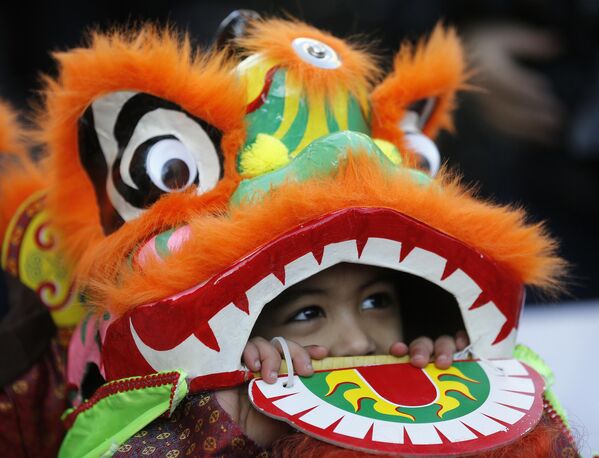 Children dressed as a dragon performs during the parade to mark Chinese new year in Chinatown district in London, Sunday, Feb. 18, 2018. - Sputnik Africa