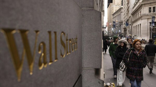 People walk past a Wall Street sign outside the New York Stock Exchange - Sputnik Africa