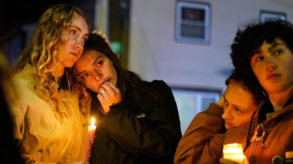 People linger after a vigil for the victims of Wednesday's mass shootings, Sunday, Oct. 29, 2023, outside the Basilica of Saints Peter and Paul in Lewiston, Maine. - Sputnik Africa