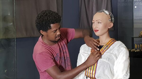 In this photo of Monday July 2, 2018, Getnet Assefa, the Founder and CEO of iCog Labs is photographed with humanoid robot Sophia at the Ethiopian National Museum in Addis Ababa. - Sputnik Africa