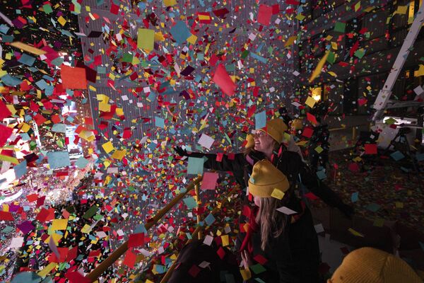 Times Square Alliance volunteers throw confetti as the clock strikes midnight as seen from the New York Marriott Marquis during the New Year&#x27;s Eve celebration in Times Square, early Monday, Jan. 1, 2024, in New York. - Sputnik Africa