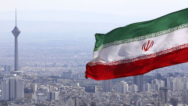  In this March 31, 2020, file photo, Iran's national flag waves as Milad telecommunications tower and buildings are seen in Tehran, Iran - Sputnik Africa