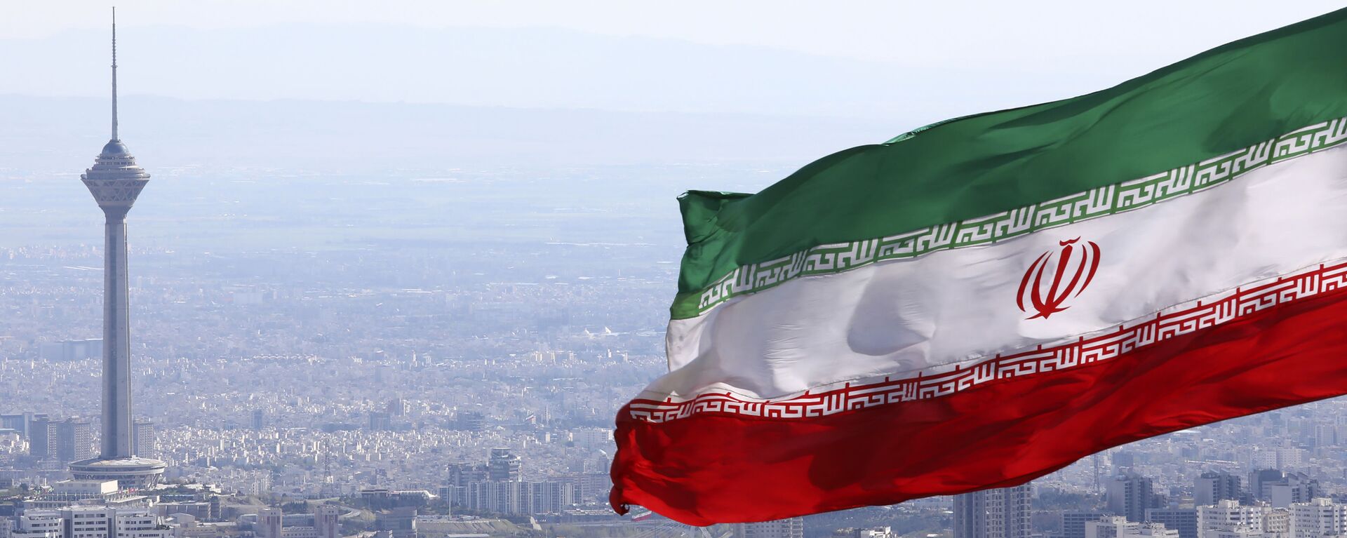  In this March 31, 2020, file photo, Iran's national flag waves as Milad telecommunications tower and buildings are seen in Tehran, Iran - Sputnik Africa, 1920, 30.03.2024