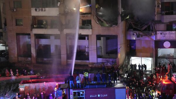Firefighters extinguish the fire inside an apartment following a massive explosion in the southern suburb of Beirut, Lebanon - Sputnik Africa