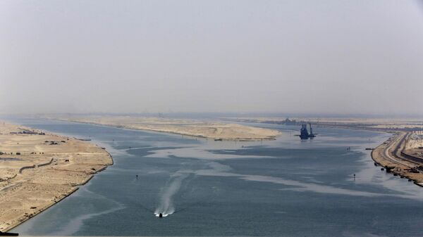n this Aug. 6, 2015 file photo, an army zodiac secures the entrance of the new section of the Suez Canal in Ismailia, Egypt.  - Sputnik Africa