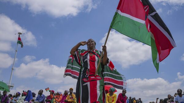 A woman waves a Kenyan flag during the 60th Jamhuri Day Celebrations (Independence Day) at Uhuru gardens Stadium in Nairobi, Monday, Dec. 12, 2023. - Sputnik Africa