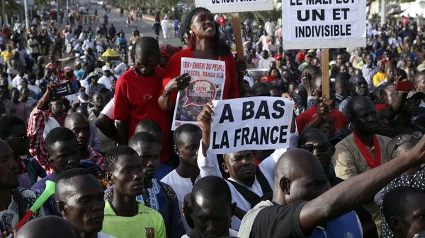 In this photo taken on Friday, Nov. 15, 2019, people hold signs reading in French down with France Mali is one and indivisible' and no to the misappropriation of our funds during a protest against France but showing support to the Malian army and the families of Malian soldiers who died during the fight against terrorism, at the Independence square in Bamako, Mali. - Sputnik Africa