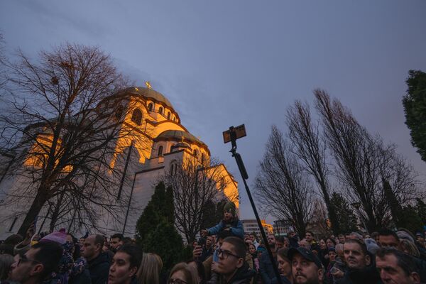 People gather during the annual ceremony of bonfire of dried oak branches, the Yule log symbol for the Orthodox Christmas eve according to the Julian calendar, at the Church of Saint Sava in Belgrade, Serbia. - Sputnik Africa