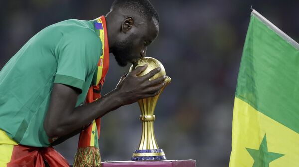 Senegal's Cheikhou Kouyate kisses trophy after winning the African Cup of Nations 2022 final soccer match between Senegal and Egypt at the Ahmadou Ahidjo stadium in Yaounde, Cameroon, Sunday, Feb. 6, 2022. - Sputnik Africa